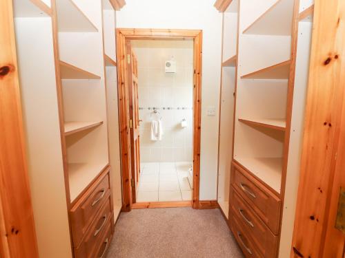a bathroom with a walk in shower and a walk in closet at 29 Church Field in Doonbeg