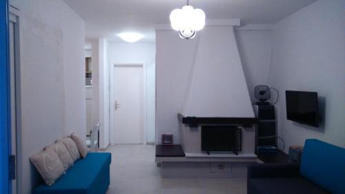 a living room with a couch and a tv at Apartment Lena in Čižići
