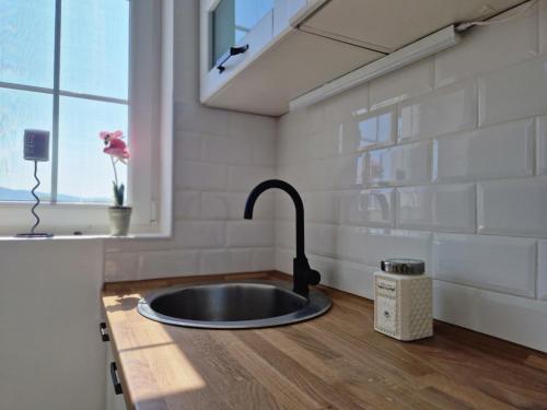 a kitchen with a sink and a window at Apartman REA 1 in Pirot