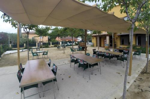 a group of tables and chairs under a tent at Hotel Les Roques in Báscara
