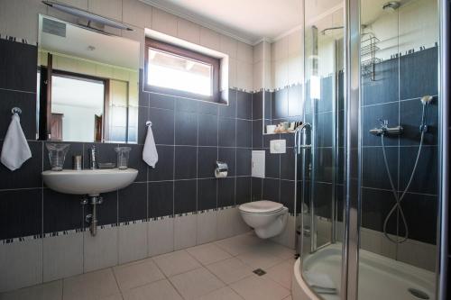 a bathroom with a toilet and a sink and a shower at Villa Golf and Relax in Balchik