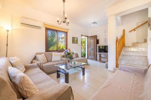 a living room with a couch and a table at The River House in Trimiklini