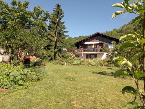 a large yard with a house in the background at CHALET HARMONIE in Auris