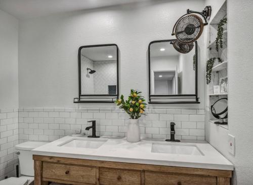 a white bathroom with a sink and two mirrors at Horseshoe Bay Resort in Horseshoe Bay