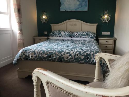 a bedroom with a bed and a chair in it at Seaham in Weymouth