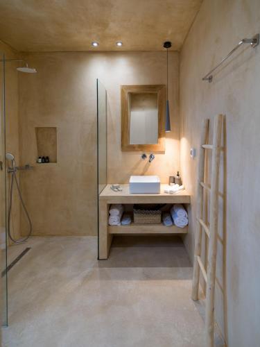 a bathroom with a sink and a shower at Terra Oleana Cottages in Vasilikos