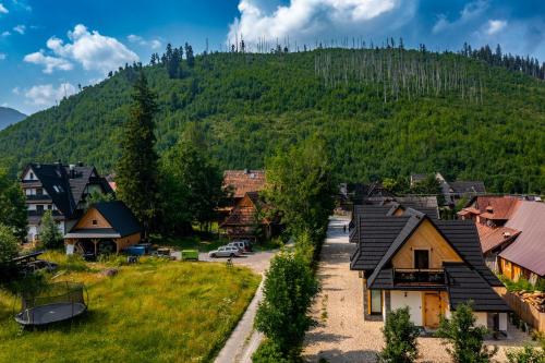 a village with a mountain in the background at Osada Zbójnicka Turnia in Kościelisko