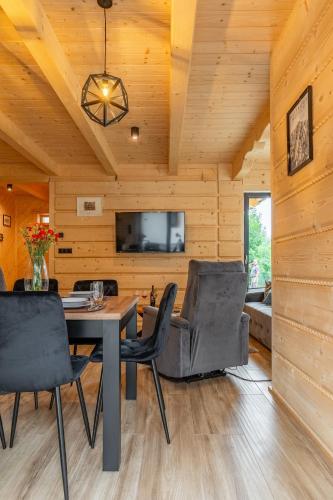 a dining room with a table and chairs at Osada Zbójnicka Turnia in Kościelisko