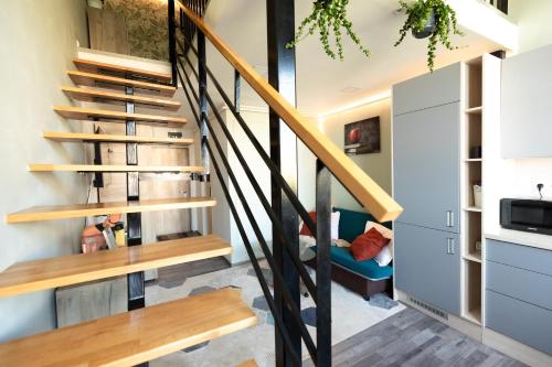 a staircase in a house with wooden rails at VIVO Loft Short Stay in Baia Mare