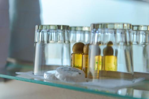 a shelf with a bunch of bottles of oil at Hôtel Rembrandt in Tangier