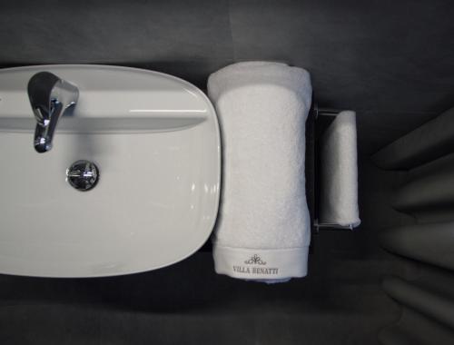 a roll of toilet paper on the side of a sink at Villa Benatti in Carpi