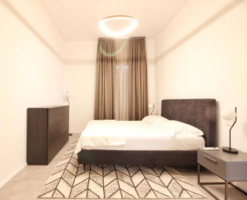 a bedroom with a bed and a large window at Villa Benatti in Carpi