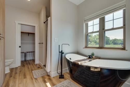a bathroom with a bath tub and a window at Idyllic Williamstown Retreat with Hot Tub and Pool! in Williamstown