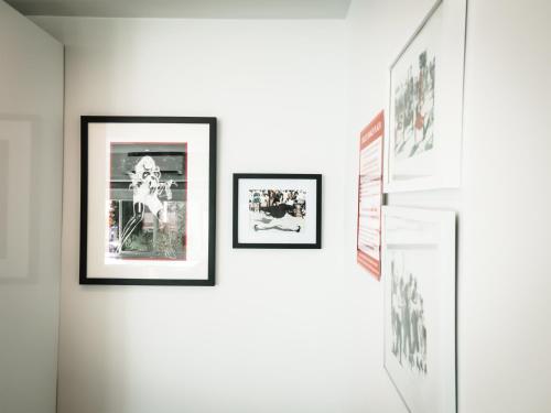 a group of pictures on a wall in a room at The Redline Venice in Los Angeles
