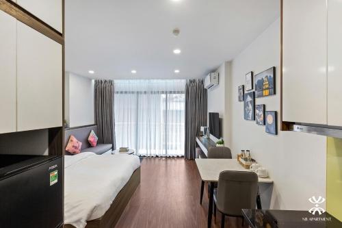 a hotel room with a bed and a table at NB APARTMENT - KIM MA in Hanoi