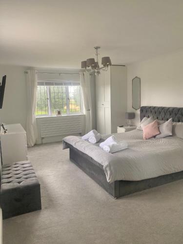 a bedroom with a large bed and a window at Boundary Farm in Middleton