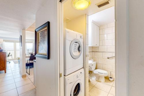 a laundry room with a washer and dryer in it at Ocean Escape By the Sea in Galveston