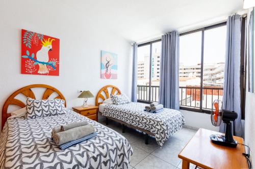 a bedroom with two beds and a window at Apartment Veracruz Sunrises, Las Americas in Playa de las Americas