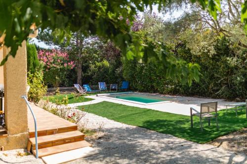 a backyard with a swimming pool and a lawn at Villa Naladijo 6 People heated swimming pool games 650m city center in Saint-Didier