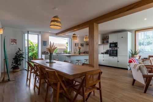 une cuisine et une salle à manger avec une table et des chaises en bois dans l'établissement Beautiful Beach house in front of the Ocean, à Biarritz