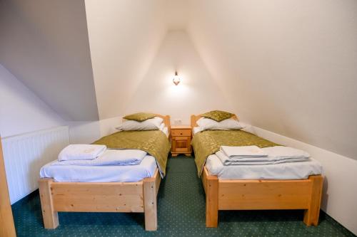 two twin beds in a small attic room at Pod Tatrami 2 - świetna lokalizacja, blisko największych atrakcji oraz restauracji in Białka Tatrzańska