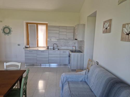 a kitchen with a couch and a table in a room at Agriturismo Camparella in Pastrengo