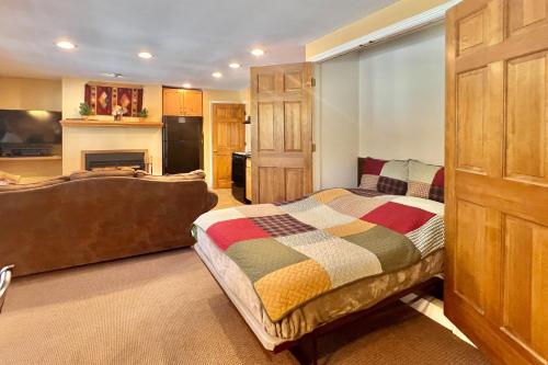 a bedroom with a bed and a living room at On the Rapids in Grand Lake