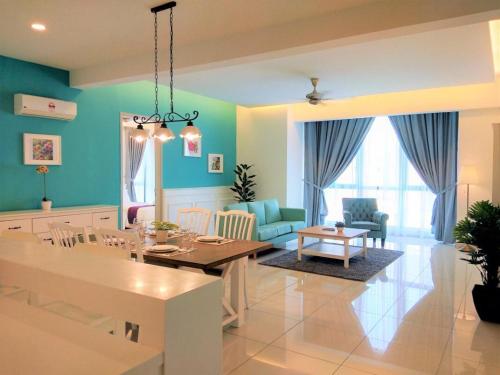 a dining room and living room with blue walls at Jazz Service Suite Tanjung Tokong in Bagan Jermal