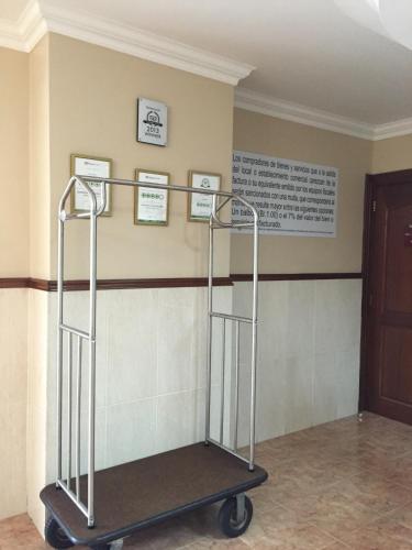 a serving cart in a room with a wall at Hotel Milan Panama in Panama City