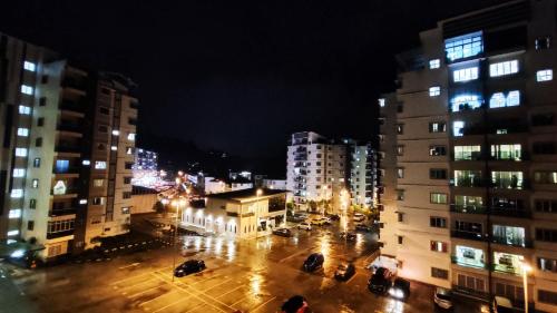 a city at night with cars parked on a street at A ONE Holiday Apartment in Tanah Rata