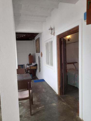 a room with a table and a room with a bedroom at Shoba Traveller's Tree in Galle