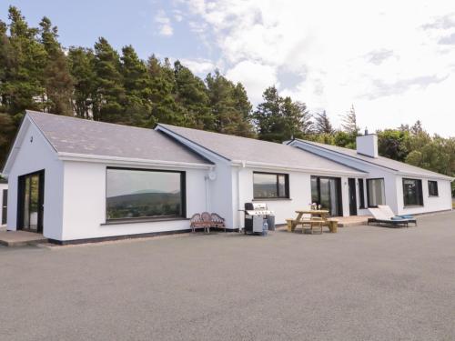 a white house with a lot of windows at Upper Killult in Cashel Hill