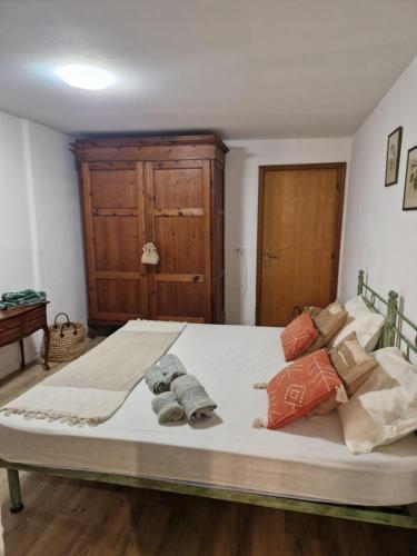 a bedroom with a large bed with pillows on it at La tavernetta in Incisa in Valdarno