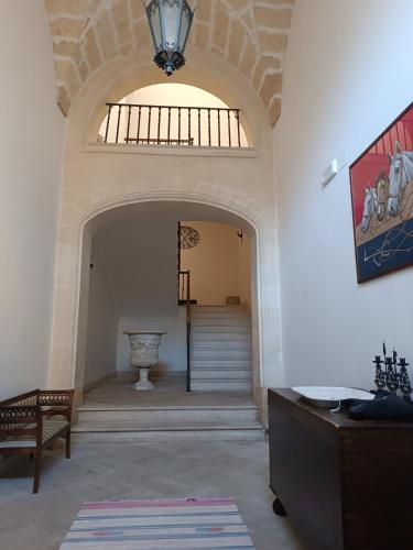 a hallway with an archway and a staircase in a building at B&B Palazzo Giordano Luxury Rooms in Squinzano
