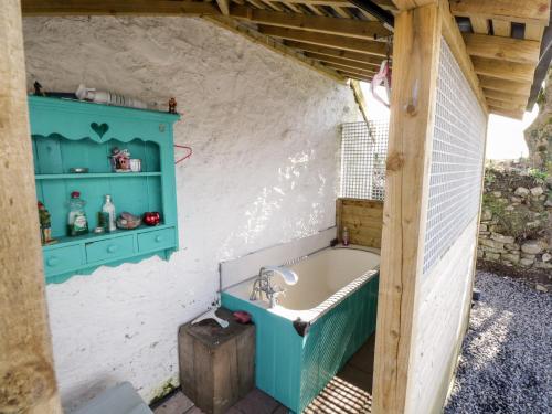 a bathroom with a bath tub in a shed at The Derries 