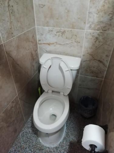 a bathroom with a white toilet in a stall at Mountain View Lofts Guayabitos in Rincon de Guayabitos