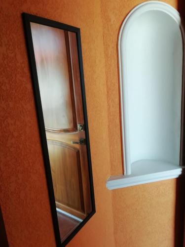 a mirror hanging on a wall next to a door at Mountain View Lofts Guayabitos in Rincon de Guayabitos