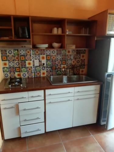 a kitchen with white cabinets and a sink at Mountain View Lofts Guayabitos in Rincon de Guayabitos
