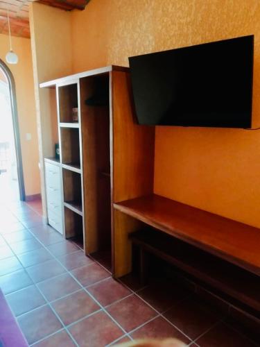 a flat screen tv hanging on a wall at Mountain View Lofts Guayabitos in Rincon de Guayabitos