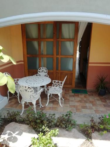 a patio with a table and chairs on a porch at Mountain View Lofts Guayabitos in Rincon de Guayabitos