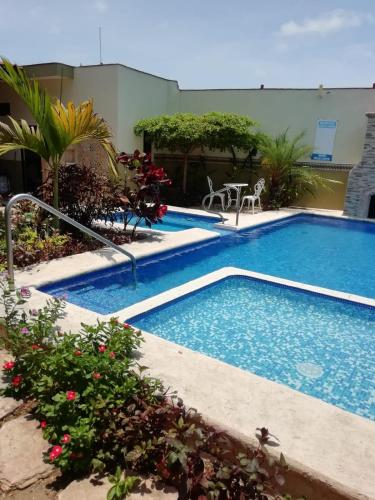a swimming pool in the middle of a resort at Mountain View Lofts Guayabitos in Rincon de Guayabitos