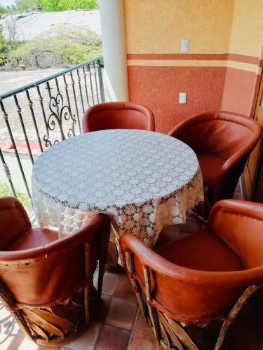 a table and chairs on a balcony at Mountain View Lofts Guayabitos in Rincon de Guayabitos