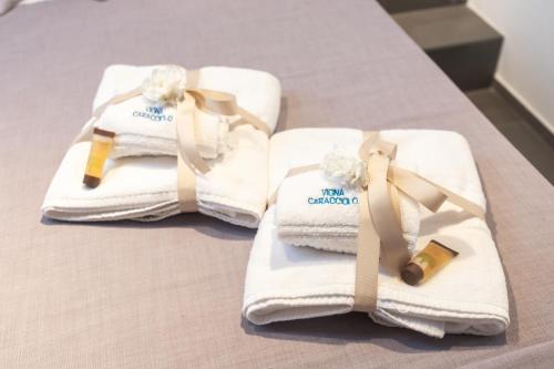a group of towels sitting on a bed at Vigna Caracciolo in Trani