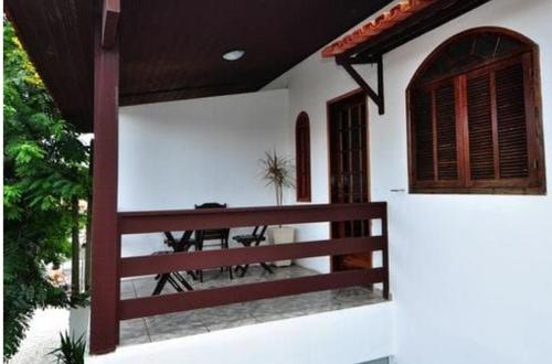 a porch of a house with a wooden fence at Pousada do Marinho in Búzios