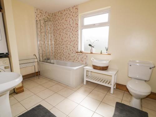 ein Badezimmer mit einem WC, einer Badewanne und einem Waschbecken in der Unterkunft Kincasslagh in Gortnasate