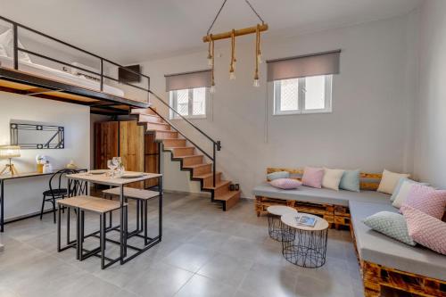 a living room with a couch and a table at LUNA & TERRA APARTMENTS SYROS in Ermoupoli