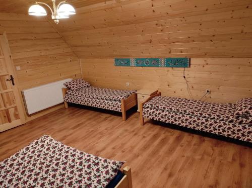Habitación con 2 camas en una cabaña de madera en Domek Góralski w Jurgowie en Jurgów
