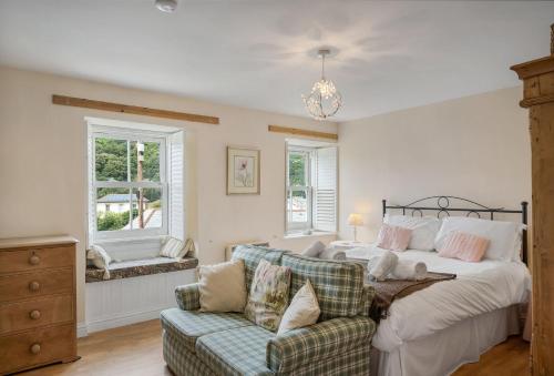 a bedroom with a bed and a couch at The Boy's Cottage in Portreath