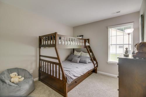 a bedroom with a bunk bed and a chair at Cozy North Carolina Abode - Minutes from Downtown! in Mount Holly