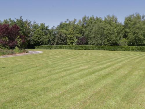 a large grassy field with trees in the background at The White House in Drumshanbo